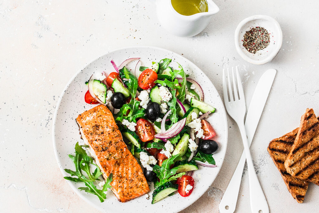 Mediterranean Diet meal of salmon, salad, and olive oil