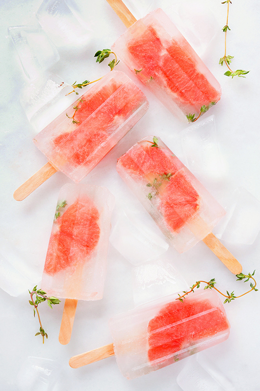 Homemade ice pops with fruit pieces