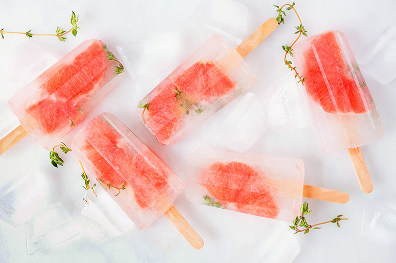 Homemade ice pops with fruit pieces