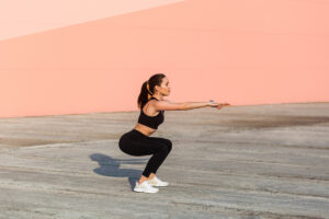 Woman performing squat exercise with proper form