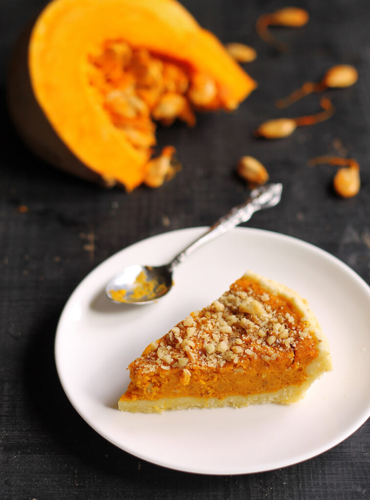 Pumpkin pie with fresh slice of pumpkin