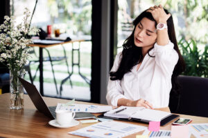 Woman stretching at her office desk